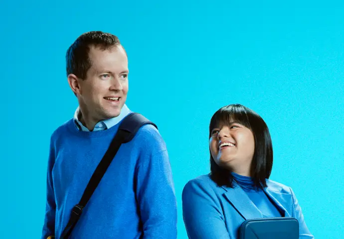 Two people looking towards each other wearing blue ready for work