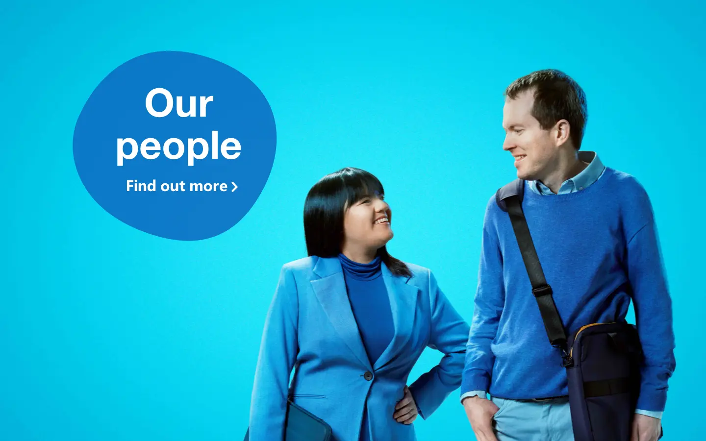 Two people looking towards each other wearing blue ready for work