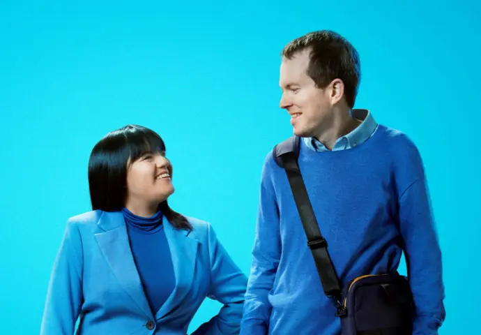 Two people looking towards each other wearing blue ready for work